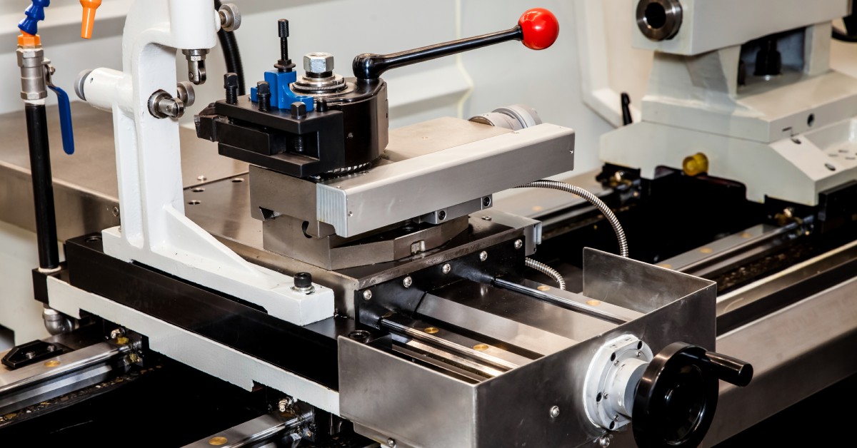 A conventional precision lathe machine with a servo drive. The machine is in a facility with even overhead lighting.